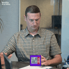 a man in a plaid shirt is holding a club pass