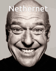 a black and white photo of a smiling bald man with the word nethernet on the top