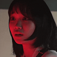 a close up of a woman 's face in red light