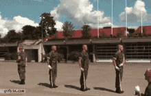 a group of soldiers standing in a line with a gifbin.com watermark