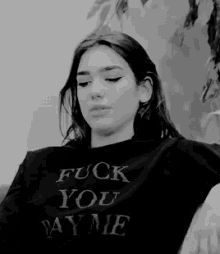 a woman wearing a shirt that says fuck you pay me