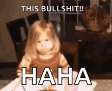 a little girl is sitting at a table with the words `` this bullshit !! haha '' written on it .