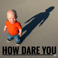 a baby is standing next to a sign that says " how dare you "