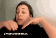 a woman is making a funny face while holding her hands to her face .