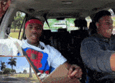 a man wearing a nike headband sits in a car