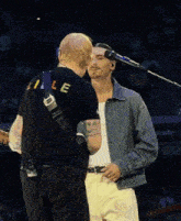a man wearing a black shirt with the letter le on it