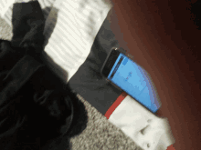 a cell phone laying on a bed with a google search page open