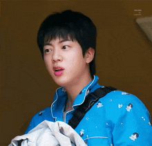 a close up of a person wearing a blue shirt that says ' moon time ' on it