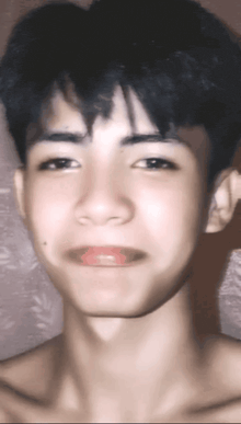 a young man without a shirt is making a funny face with his mouth open
