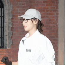 a woman wearing glasses and a white shirt has a name tag on her shirt that says ' eunhwa ' on it