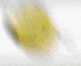 a blurred image of a yellow smiley face with headphones on a white background .