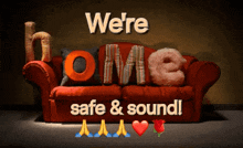 a red couch with the words " we 're safe & sound " written on it