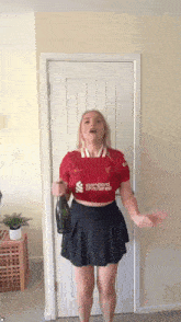 a woman is wearing a red shirt that says standard chartered