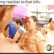 a woman is talking to another woman in a crowd of people with the caption " my reaction to that info " .