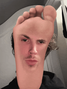 a picture of a man 's face with a foot instead of his face