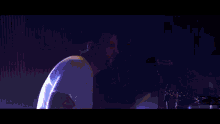 a blurred image of people raising their hands in the air at a concert