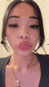 a woman with a nose ring is wearing a necklace