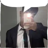 a man in a suit and tie is taking a selfie