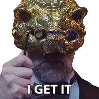 a man in a suit and bow tie is holding a magnifying glass in front of a mask that says " i get it "