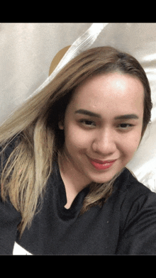 a woman taking a selfie with her hair in the foreground