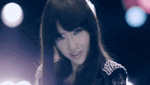 a woman with long hair is smiling and looking at the camera