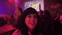 a woman says we 're in front of a large screen