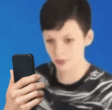 a blurry picture of a woman holding a cell phone