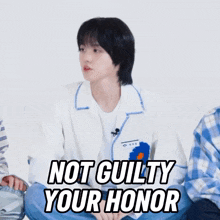 a person sitting on the floor with the words " not guilty your honor " written on the bottom