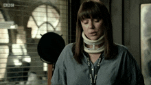 a woman with a neck brace and a police lanyard