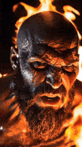 a close up of a man with a beard in front of fire
