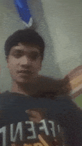 a blurry picture of a young man wearing a shirt that says ' always ' on it
