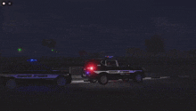 two police cars are parked next to each other in a dark area