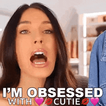 a woman with her mouth open says i 'm obsessed with cutie .