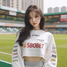 a girl wearing a white sweater with sbobet on it
