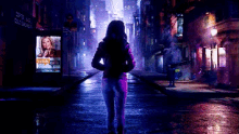 a woman in a pink jacket is walking down a street at night with a sign that says cold washing on it