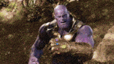 a purple thanos holding a infinity gauntlet in his hand