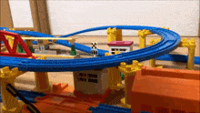 a toy train set with a crossing sign