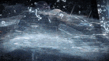 a person is swimming in a pool of water with bubbles coming out of it
