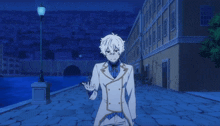 a man in a white suit stands in front of a street light
