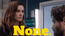 a woman and a man are looking at each other with the word none written in yellow