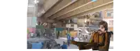 a man is standing under a bridge with a gun in his hand