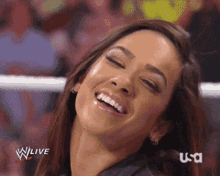 a woman is smiling in front of a screen that says wlive