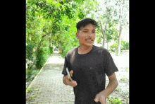 a young man wearing a black t-shirt with the letter a on it