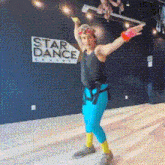 a person is dancing in front of a sign that says star dance canada