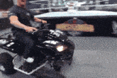 a man is riding a motorcycle in front of a wrestling ring that says battlepedia