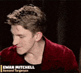 a man in a red jacket is smiling and holding a red cup .
