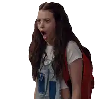 a girl wearing overalls and a red backpack has her mouth open