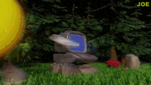 a computer sitting in the grass with the word joe in the corner