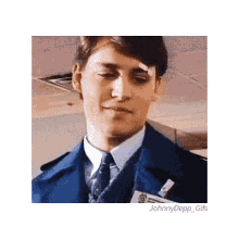 a man in a suit and tie has a bandage on his forehead and a name tag that says johnny depp gifs