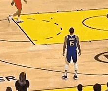a basketball player on a court with the letter r visible